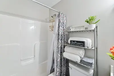 a bathroom with a towel rack with towels at Corinth Getaway with Deck about 11 Mi to Ark Encounter! in Corinth