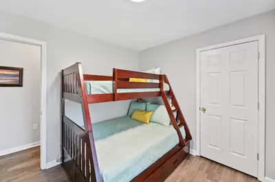 a bunk bed in a room with a door at Corinth Getaway with Deck about 11 Mi to Ark Encounter! in Corinth