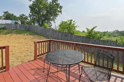 a patio with a table and chairs on a deck at Corinth Getaway with Deck about 11 Mi to Ark Encounter! in Corinth