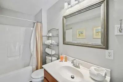 a white bathroom with a sink and a mirror at Corinth Getaway with Deck about 11 Mi to Ark Encounter! in Corinth