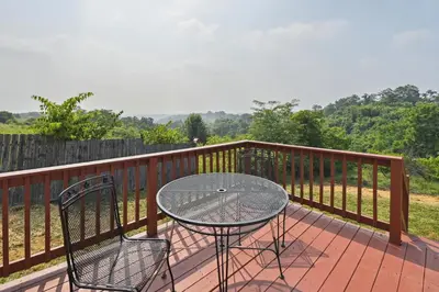 a table and two chairs sitting on a deck at Corinth Getaway with Deck about 11 Mi to Ark Encounter! in Corinth