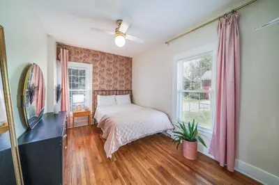 a bedroom with a bed and a window at Small town vibes in Garrettsville. in Garrettsville