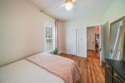 a bedroom with a bed and a dresser and a mirror at Small town vibes in Garrettsville. in Garrettsville