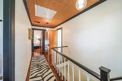 a hallway with a staircase with a ceiling at Small town vibes in Garrettsville. in Garrettsville