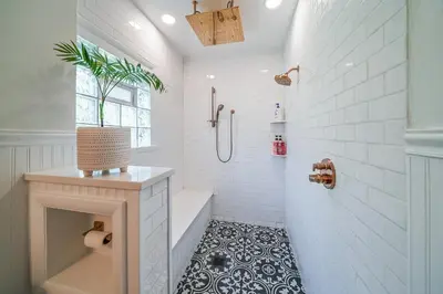 a bathroom with a tub and a shower with white tiles at Small town vibes in Garrettsville. in Garrettsville