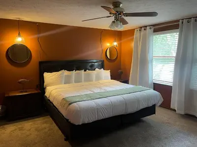 a bedroom with a bed and a ceiling fan at Rye Beach Family Cottage in Huron