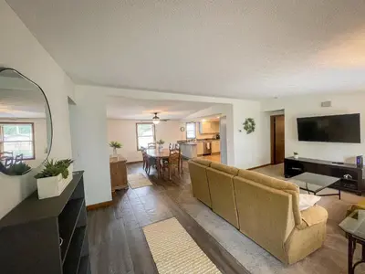a living room with a couch and a table at Rye Beach Family Cottage in Huron