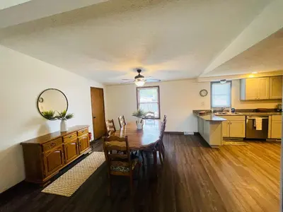 a kitchen and dining room with a table and chairs at Rye Beach Family Cottage in Huron