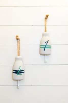 three white vases hanging on a wall at Explorers Cottage at Rye Beach in Huron