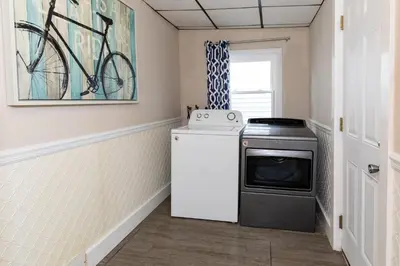 a laundry room with a washer and dryer at Explorers Cottage at Rye Beach in Huron