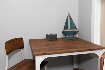 a wooden table with a sailboat on top of it at Downtown Waterfront Escape in Sandusky