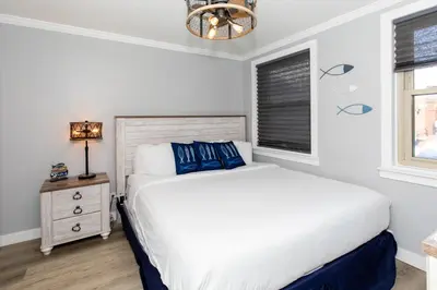 a bedroom with a bed and a window at Downtown Waterfront Escape in Sandusky