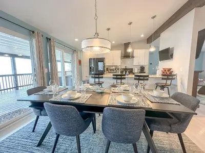 a dining room and kitchen with a table and chairs at Lakefront 5 Bedroom Vacation Home - Sleeps 12! in Vermilion