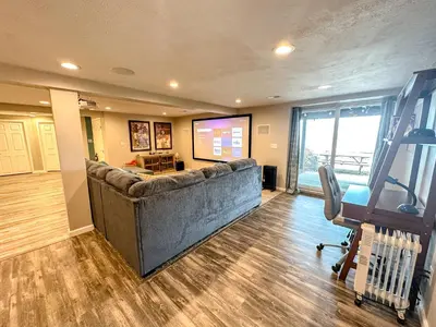 a living room with a large couch in a room at Lakefront 5 Bedroom Vacation Home - Sleeps 12! in Vermilion