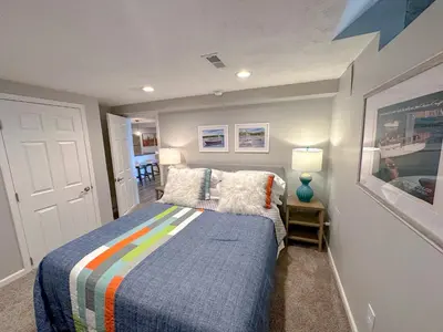 a small bedroom with a bed with a colorful blanket at Lakefront 5 Bedroom Vacation Home - Sleeps 12! in Vermilion