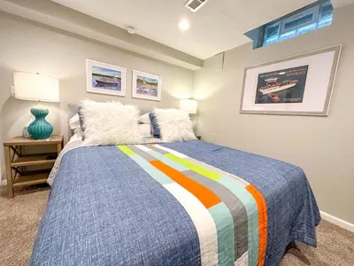 a bedroom with a bed with a colorful blanket at Lakefront 5 Bedroom Vacation Home - Sleeps 12! in Vermilion