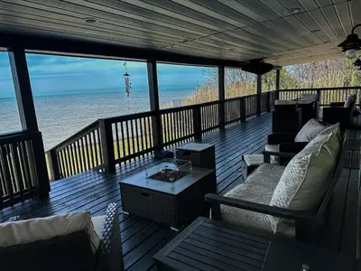 a screened in porch with a view of the ocean at Lakefront 5 Bedroom Vacation Home - Sleeps 12! in Vermilion