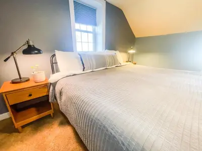a bedroom with a white bed and a window at Charming School House with Large Pool in Huron