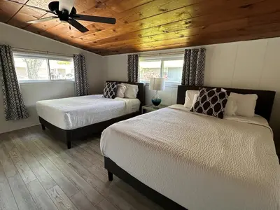 a bedroom with two beds and a ceiling fan at Newly Renovated! Old Homestead Beach Home in Huron
