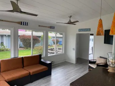a living room with a couch and a table at Newly Renovated! Old Homestead Beach Home in Huron