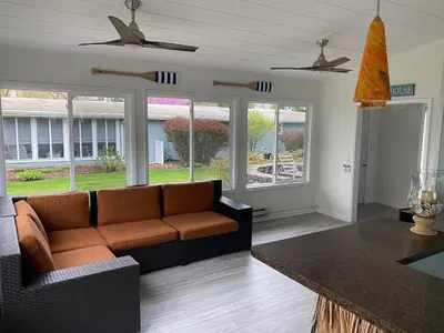 a living room with a couch and a table at Newly Renovated! Old Homestead Beach Home in Huron