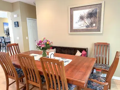 a dining room with a wooden table and chairs at 5 Bedroom Home in Old Homestead II in Huron
