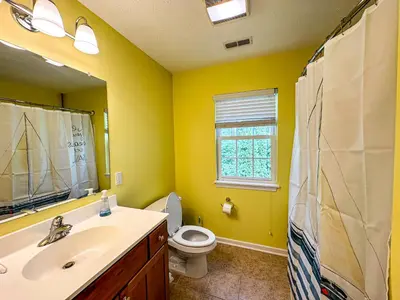 a bathroom with a sink and a toilet and a window at 5 Bedroom Home in Old Homestead II in Huron