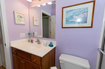 a bathroom with a sink and a toilet and a mirror at 5 Bedroom Home in Old Homestead II in Huron