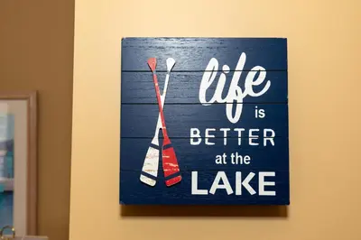 a sign that says life is better at the lake at 5 Bedroom Home in Old Homestead II in Huron