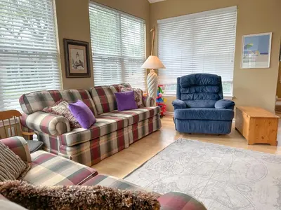 a living room with a couch and a chair at 5 Bedroom Home in Old Homestead II in Huron