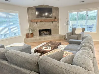 a living room with a couch and a fireplace at Group House Sleeps 26 THE ATTIC - 2 Miles to Cedar Point in Sandusky