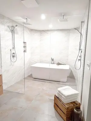 a white bathroom with a tub and a shower at Group House Sleeps 26 THE ATTIC - 2 Miles to Cedar Point in Sandusky