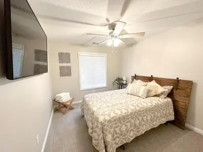 a bedroom with a bed and a ceiling fan at Group House Sleeps 26 THE ATTIC - 2 Miles to Cedar Point in Sandusky