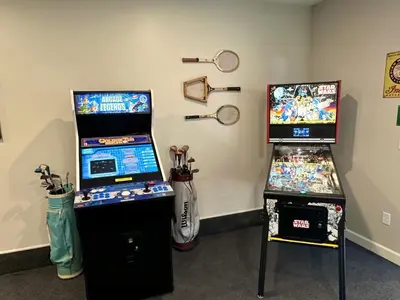 two video game machines sitting next to each other at Group House Sleeps 26 THE ATTIC - 2 Miles to Cedar Point in Sandusky