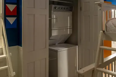 a kitchen with a refrigerator and a washer and dryer at Marlin at the Lake - Downtown Sandusky in Sandusky