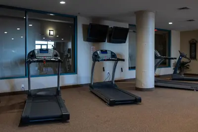 a gym with two treadmills in a room at Marlin at the Lake - Downtown Sandusky in Sandusky