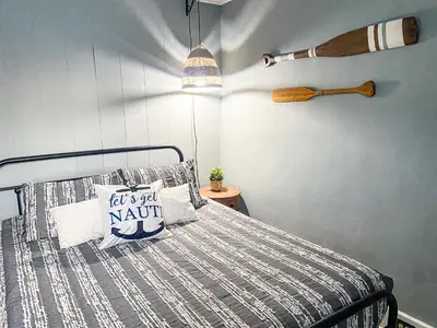 a bedroom with a bed with a wooden headboard and aannisannis at Historic District Vermilion Home in Vermilion