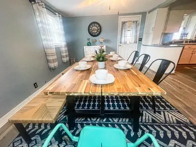 a dining room with a wooden table and chairs at Historic District Vermilion Home in Vermilion