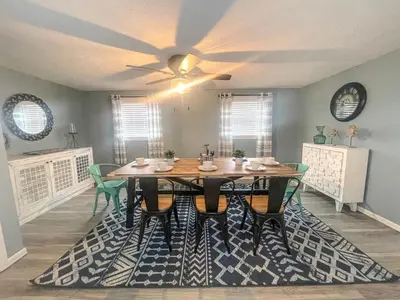 a dining room table with chairs and a ceiling fan at Historic District Vermilion Home in Vermilion