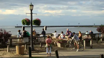 a group of people standing on a pier near the water at Historic District Vermilion Home in Vermilion