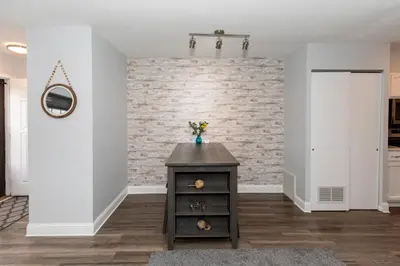 a living room with a brick wall at Side-by-Side Family Apartments - Sleeps 15 Total in Huron