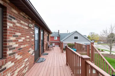 a wooden deck on the side of a house at Side-by-Side Family Apartments - Sleeps 15 Total in Huron