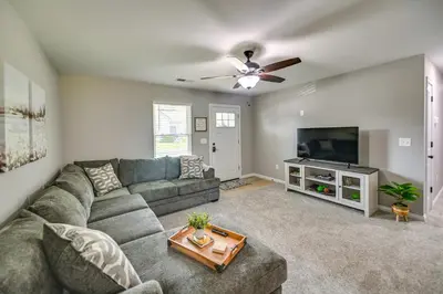 a living room with a couch and a flat screen tv at Serene Dry Ridge Vacation Rental with Nearby Fishing in Dry Ridge