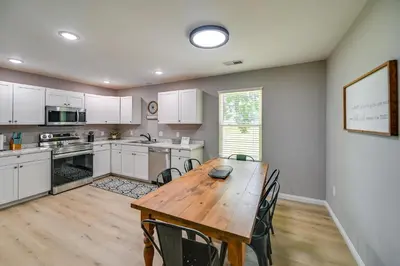 a kitchen with a wooden table and chairs at Serene Dry Ridge Vacation Rental with Nearby Fishing in Dry Ridge
