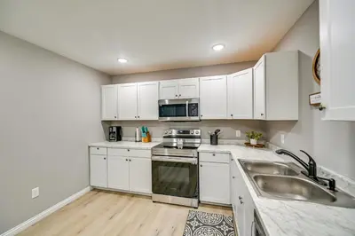 a kitchen with white cabinets and a sink at Serene Dry Ridge Vacation Rental with Nearby Fishing in Dry Ridge