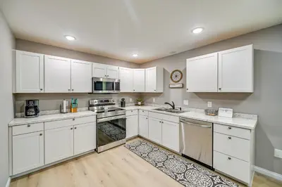 a kitchen with white cabinets and white appliances at Serene Dry Ridge Vacation Rental with Nearby Fishing in Dry Ridge