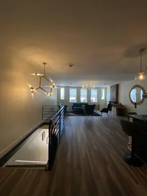 a large living room with a staircase and a dining room at Modern & Luxurious 1 Bedroom in the Heart of Short North in Columbus