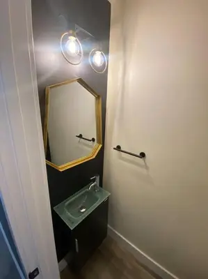 a bathroom with a sink and a mirror at Modern & Luxurious 1 Bedroom in the Heart of Short North in Columbus