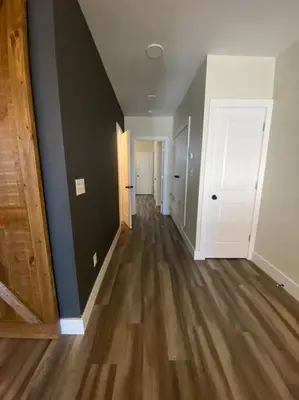 an empty hallway of an empty house with wood floors at Modern & Luxurious 1 Bedroom in the Heart of Short North in Columbus