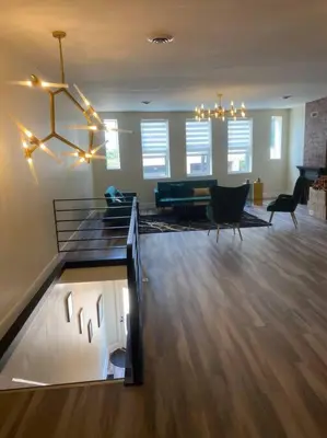 a living room with a couch and a dining room at Modern & Luxurious 1 Bedroom in the Heart of Short North in Columbus